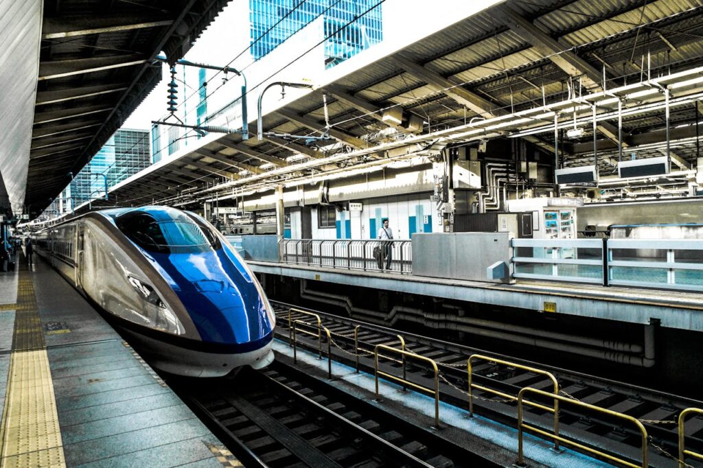 Sleek bullet train at a busy city station, epitomizing speed and modern transportation.